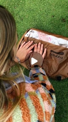 a woman with her hands on top of a brown bag