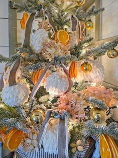 a decorated christmas tree with oranges and silver ornaments