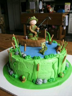 a birthday cake with a man fishing on the lake and golf in the pond,