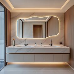 a bathroom with two sinks and a large mirror