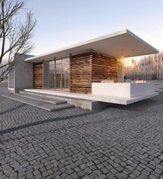 an architectural rendering of a modern house on cobblestone pavement with trees in the background