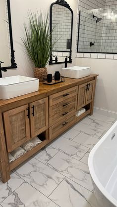 a bathroom with two sinks and a bathtub