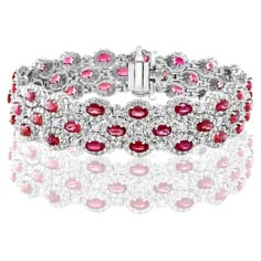 A beautiful vivid red Rubies and Diamond 3-row bracelet showcasing color-rich Rubies, surrounded by a single row of brilliant round diamonds. 51 Oval cut rubies weigh 14.91 carats total; 561 accent diamonds weigh 9.66 carats total. Made in 14k white gold. Style is available in different price ranges. Prices are based on your selection. Please contact us for more information. Luxury Red Diamond Jubilee Bracelet, Luxury Red Ruby Tennis Bracelet, Luxury Red Diamond Bracelet, Red Luxury Diamond Bracelet, Red Oval Diamond Gemstone Bracelet, Luxury Red Diamond Bracelet For Anniversary, Luxury Red Tennis Bracelet, Red Luxury Jubilee Tennis Bracelet, Red Diamond Oval Bracelet