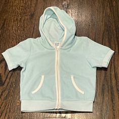 Uniqlo Short Sleeve Hoodie Size 12-18m. Zip Close. New With Tags. Unisex Cotton Hooded Hoodie For Playwear, Cotton Hooded Sweatshirt For Playwear, Hooded Cotton Sweatshirt For Playwear, Cotton Playtime Hoodie Outerwear, Cotton Hoodie With Adjustable Hood For Playtime, Light Blue Cotton Outerwear With Drawstring Hood, Sporty Hooded Hoodie For Playtime, Cute Blue Hoodie Top, Cotton Hooded Hoodie For Playtime