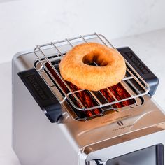 a donut sitting on top of a toaster oven