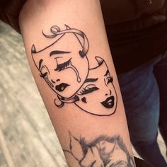 a woman's arm with two masks on it