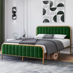 a bed with green velvet headboard and foot board in a white walled bedroom area