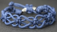 a blue bracelet with an intricate knot on it