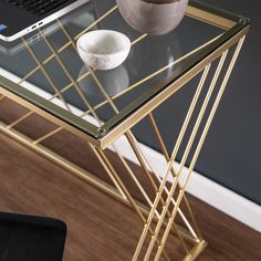 a glass table topped with a laptop computer