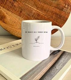 a white coffee mug sitting on top of a wooden tray