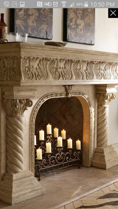 an ornate fireplace with candles lit in it