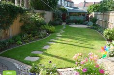 a garden with grass and stepping stones in the middle