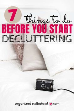 a camera sitting on top of a bed with the words 7 things to do before you start decluttering