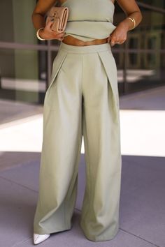 Introducing our So Iconic Pant, a must-have for NYC fashion lovers. Featuring stunning pleated details, high waisted design, and oversized silhouette, these pants exude chic and sophistication. With a relaxed fit and oversized style, they offer both comfort and elevated style, perfect for any occasion from bridal to workwear. Upgrade your wardrobe with these trendy and classy pants that combine comfort and style effortlessly. * So Iconic Top sold separately Self 100% Polyester Lining 100% Polyester Hand wash cold. Classy Pants, Satin Pants, Elevated Style, Oversized Style, I Like That, Nyc Fashion, Oversized Silhouette, Upgrade Your Wardrobe, Dresses Xs