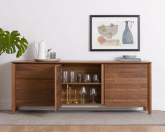 a wooden cabinet with wine glasses on it