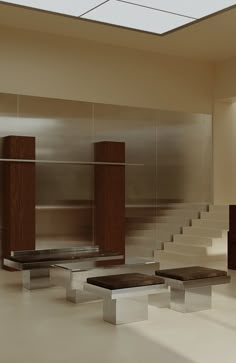 an empty room with stairs and tables in front of the wall that is made out of metal