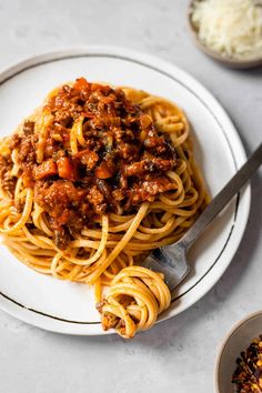 a white plate topped with spaghetti and sauce