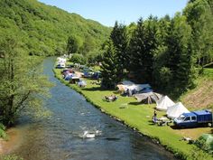 tents set up on the bank of a river