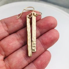 "Gold Bar Earrings - Minimalist Earrings - Everyday Earrings - Jewelry gift for her - Slim Rectangle Earrings - Geometric Earrings - Long Earrings 1 1/2\" gold filled slim bars are given a hammered finish to catch the light. The earwires are hand formed from gold filled wire. The earrings measure about 2\" total from the top of the earwire to the bottom of the bar. *Also available in sterling silver and rose gold filled. Just choose your metal from the drop down box*" Rectangular Metal Earrings For Gifts, Rectangular Metal Earrings For Gift, Modern Hammered Rectangular Earrings, Elegant Hammered Rectangular Earrings, Elegant Rectangular Hammered Earrings, Rectangular Linear Earrings For Gift, Rectangular Single Earring For Gift, Oblong Jewelry With Matching Earrings For Gifts, Minimalist Hammered Rectangular Earrings