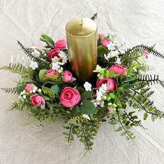 a candle and some flowers on a table