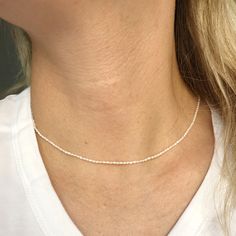 "A tiny natural Pearl beads choker necklace. Perfect as a gift for someone you love or even for yourself for birthday gift or any other special occasions like Christmas gift, Mother's day gift, Valentines day gift, a wedding, or the celebration of an anniversary. ► Please check our Add-on section to add name disc and turn your jewelry to a personal gift - https://www.etsy.com/listing/557860024/add-on-gold-filled-disc-sterling-silver?ref=shop_home_active_3&frs=1 ------------------------------ Dainty White Hypoallergenic Charm Necklace, White Dainty Hypoallergenic Charm Necklace, White Sterling Silver Choker Necklace, Delicate Adjustable Beaded Necklace Gift, Delicate Adjustable Beaded Necklace For Gift, Delicate Adjustable Beaded Necklaces For Gifts, Minimalist Hypoallergenic White Charm Necklace, Simple Adjustable Charm Necklaces With Delicate Chain, Simple Adjustable Charm Necklace With Delicate Chain