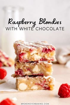 three raspberry white chocolate bars stacked on top of each other next to some raspberries