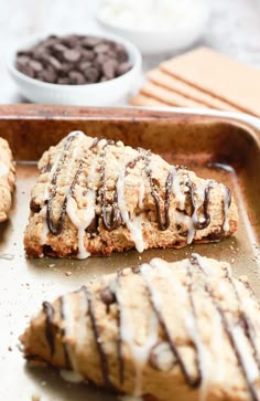 cookies with icing and chocolate chips on a baking sheet