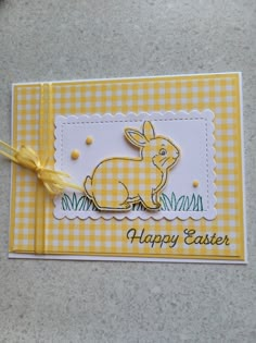 a yellow and white card with a rabbit on it