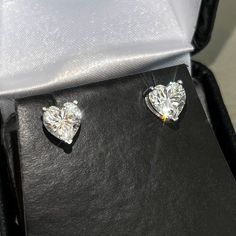 Stand out from the crowd with gorgeous heart cut studs! Moissanite offers timeless beauty and exceptional value. Our luxurious studs are GRA certified VVS1 clarity Moissanite hand set on high quality thick basket settings with screw-back posts. This is the best compromise between cheap fakes (CZ, crystal, rhinestone) and extremely expensive diamond studs. Natural diamond equivalent studs cost $10,000 - $100,000+. Get the same look at a reasonable price. Hundreds of 5 star reviews. Order your pair today! -VVS1 Clarity GRA certified Moissanite Stones -9.25 Hardness Rating. Diamonds are perfect 10, CZ is 3-4.  -Choose Rhodium (white) or Gold (yellow) finish 925 sterling silver -Passes many Thermal Diamond Testers -Comes with inner/outer box with certificate Expensive Diamond, Better Balance, Stud Design, Basket Setting, Halo Earrings Studs, Solitaire Studs, Diamond Watch, Gorgeous Earrings, 100 000