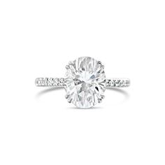 an oval cut diamond ring with pave set shoulders