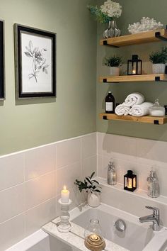 a white bath tub sitting under two framed pictures