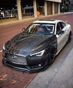 a black and white car parked on the street