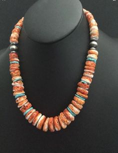 sterling silver orange spiny oyster bead necklace. The necklace measures 20 inch. Orange Sterling Silver Jewelry With Round Beads, Southwestern Orange Round Bead Necklaces, Southwestern Orange Round Beads Necklace, Southwestern Orange Beaded Necklace, Southwestern Orange Beaded Necklaces With Round Beads, Southwestern Orange Beaded Necklace With Round Beads, Southwestern Orange Round Beads Jewelry, Southwestern Orange Round Bead Jewelry, Orange Beaded Southwestern Necklace