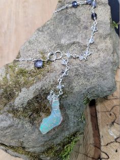 Ethiopian opal, Herkimer diamond & iolite choker. Perfect for summer as this stone looks like it has glitter inside. The glitter effect is visible in sunlight and especially indirect/indoor light. The opal also happens to be shaped like Florida 🙂 The choker is 14.5 inches with a 3 inch drop. It clasps in the front where there is a small iolite accent. The opal is hanging below a chain of Herkimer diamonds that extends up the chain and transitions to iolite. Opals are very difficult to photo Pink Opal Gemstone Jewelry Gift, Pink Opal Gemstone Jewelry For Gift, Multi-stone Moonstone Gemstones For Gift, Adjustable Opal Birthstone Jewelry, Silver Ethiopian Opal Birthstone Jewelry, Spiritual Opal Jewelry With Birthstone, Silver Ethiopian Opal Jewelry With Birthstone, Spiritual Opal Jewelry As A Gift, Pink Opal Gemstone Pendant Jewelry