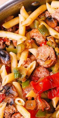 pasta with sausage, peppers and mushrooms in a skillet ready to be served on the table