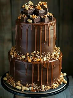 a triple layer chocolate cake with nuts on top