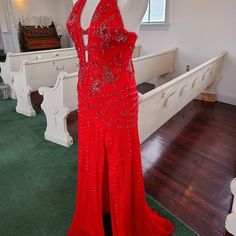 a red dress is on display in a room