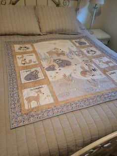 a bed with an animal themed quilt on it