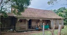 an old wooden building with a brown roof