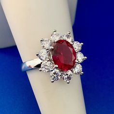 * Stunning Siri Sterling Silver Oval Ruby Cubic Zirconia CZ Halo Cocktail Ring * Ring Size: 7.0 * Top of ring measures: 3/4" x 5/8" * Band width: 1/8" * Ruby total carat weight: approximately 2.20 tcw * Cubic Zirconia CZ total carat weight: approximately 1.10 tcw * Ring weight: 4.1 tgw * Marked: Siri*925 * Condition: Great * S920 5% Restocking Fee    Exported By ExportYourStore :) White Gold Ruby Ring With Cubic Zirconia, Oval Red Cluster Ring With Center Stone, Luxury Oval Ruby Ring With Cubic Zirconia, Oval Ruby Ring With Cubic Zirconia For Anniversary, Dazzling Oval Ruby Ring With Halo Setting, Formal Oval Ruby Ring With Cubic Zirconia, Oval Ruby Ring With Cubic Zirconia For Formal Occasions, Oval Cluster Ring With Center Stone In Cubic Zirconia, Dazzling Oval Ruby Ring With Prong Setting