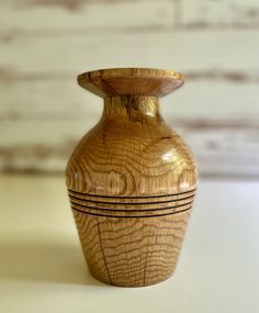 a wooden vase sitting on top of a table