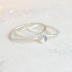 Moonstone is one of the birthstones representative of a June birthday. This stone is valued for the belief that it holds centering, calming and healing properties. It's been used as a gift for lovers and a talisman for travelers. This 4 mm rainbow moonstone is set in sterling silver. Completing your minimalist and dainty stacking set are a sterling silver twist ring and a hammered band.{DETAILS}:* 1.3 mm sterling silver band* 4 mm conflict-free moonstone►Simple and perfect, our single moonstone Silver Moonstone Stackable Rings With Birthstone, Adjustable Stackable Moonstone Ring In Sterling Silver, Adjustable Sterling Silver Stackable Moonstone Ring, Stackable Moonstone Promise Ring With Round Stone, Adjustable Stackable Moonstone Ring With Round Stone, Adjustable Stackable Sterling Silver Moonstone Ring, Adjustable Stackable Moonstone Ring, Moonstone Birthstone Stackable Rings, Minimalist Moonstone Stackable Rings As Gifts