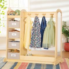 a wooden shelf with clothes hanging on it