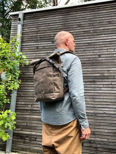 "Backpack in medium size made from waxed canvas in field tan with a volume outside pocket made in waxed canvas. I made it into an everyday backpack/rucksack, with waxed canvas padded straps. Roll to close top, and outside pocket with protective flap. The bottom is made in a double layer of waxed canvas for extra strength and durability . The bag closes with roll to close top and buckle and strap on the front in X-design made from vegetable tanned leather and easy acces on the backside with pouch Waxed Canvas Backpack For Adventure, Waxed Canvas Backpack For Hiking, Waxed Canvas Backpack With Canvas Lining For Hiking, Outdoor Cotton Backpack With Waxed Finish, Rugged Everyday Backpack With Canvas Lining, Rugged Backpack With Canvas Lining For Everyday Use, Khaki Waxed Canvas Backpack For Outdoor, Adventure Waxed Canvas Backpack, Waxed Canvas Standard Backpack