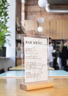 a wooden table with a menu on it