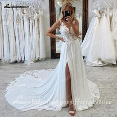 a woman is taking a selfie in front of her wedding gowns and dresses