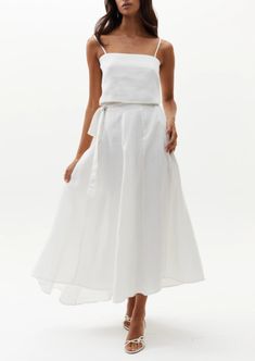 Our beloved Lola Wrap Skirt is perfectly flattering and elegant. This chic 100% linen skirt rests on the hip and flows down for a femenine silhouette. It features a tied closure with elastic waistband on the back for a perfectly adjustable fit, and on the back it has a central belt loop so that the tie stays in place. It is slightly longer on the back for a more dramatic and flirty effect. Size & Fit: Model is wearing size S/M Model’s measurements: Height: 5’ 10’’ / 179 cm Bust: 32.7’’ / 83 cm W Linen Flowy Skirt For Vacation, Flowy Linen Skirt For Vacation, Elegant Full Skirt Bottoms For Vacation, Elegant Summer Skirt With Tie Waist, Elegant Full Skirt For Vacation, Chic Flowy Tie Waist Skirt, Chic Tie Waist Flowy Skirt, Chic Flowy Skirt With Tie Waist, Elegant Summer Gathered Wrap Skirt