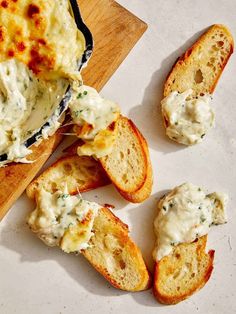 several pieces of bread with cheese spread on them