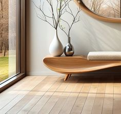 a wooden table with two vases on it