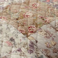 an old fashioned quilt with flowers on it